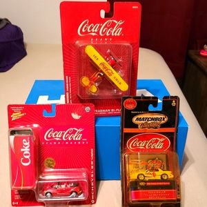 3 coca cola collectible cars and bi-plane
